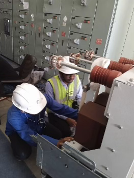 Technicians working on switchgear equipment